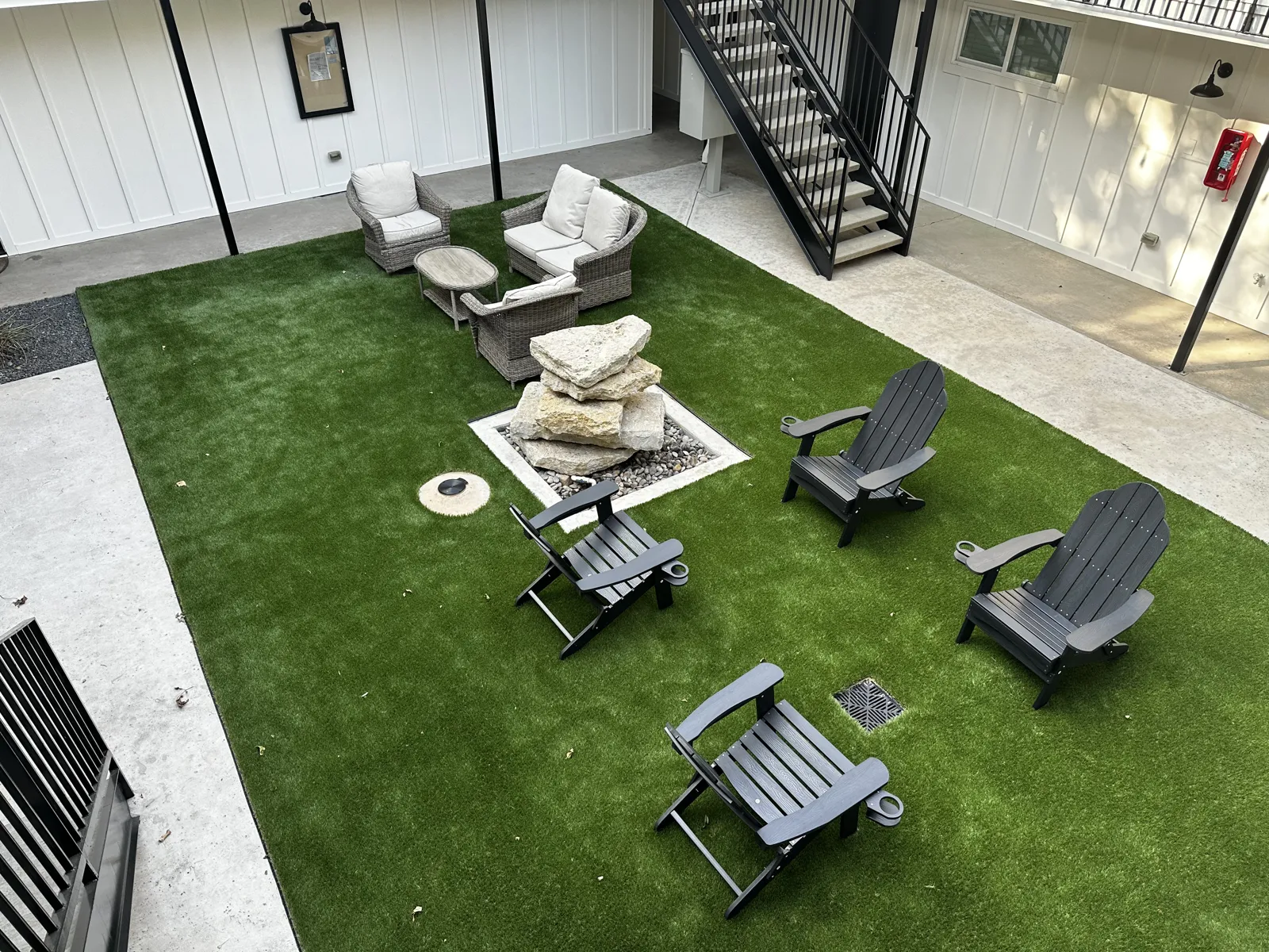 Interior courtyard at The Republic with turf lawn, lounge chairs, and balcony walkways