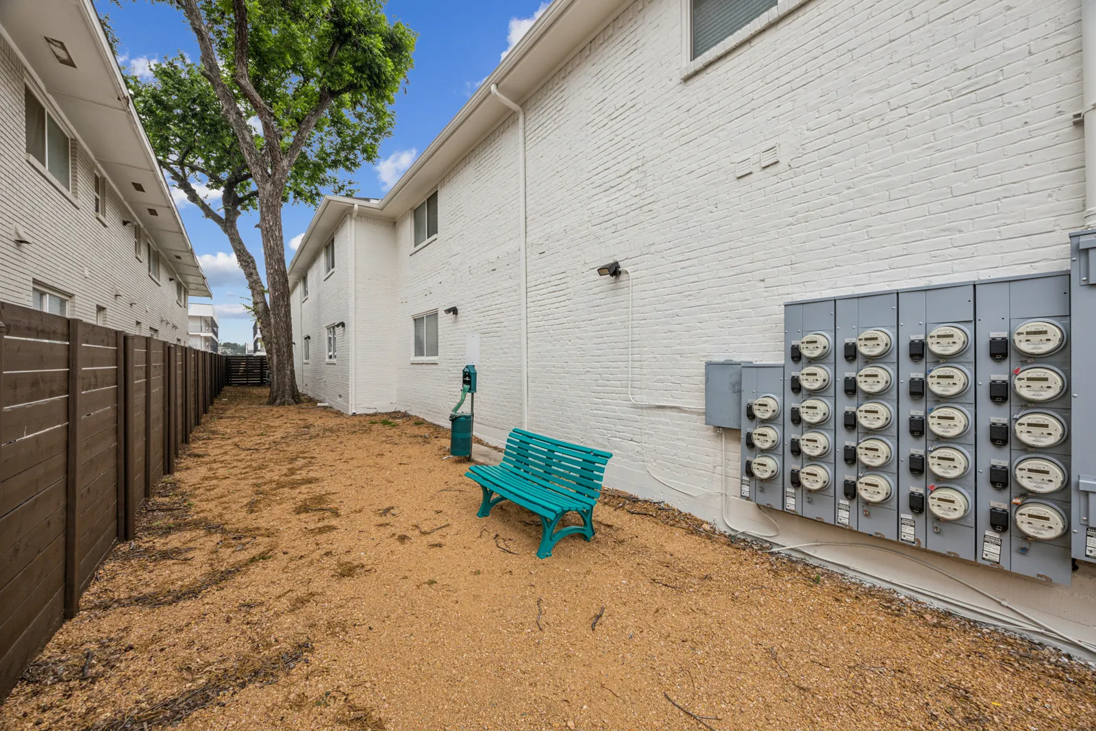 Dedicated dog run alongside the building with bench and pet waste station